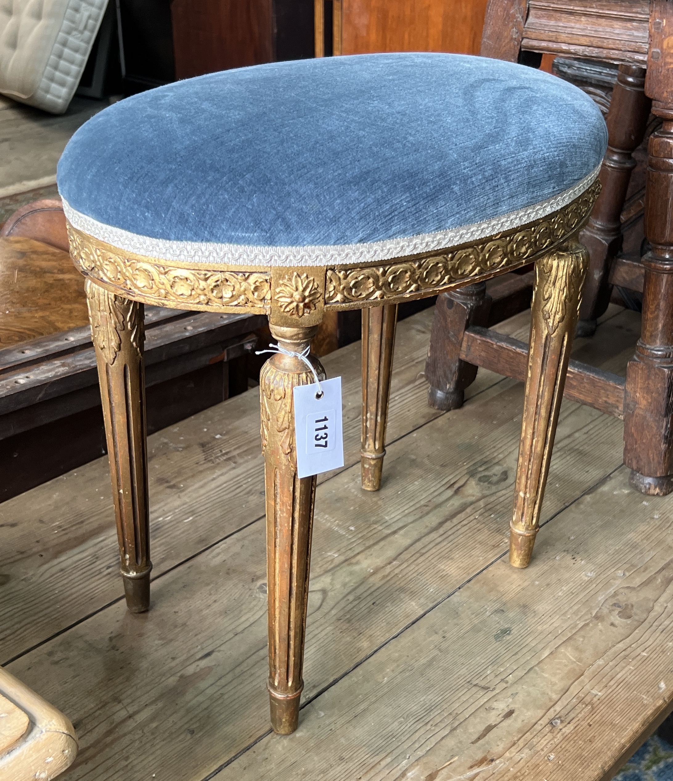 A George III style giltwood and composition oval dressing stool, width 50cm, depth 33cm, height 46cm